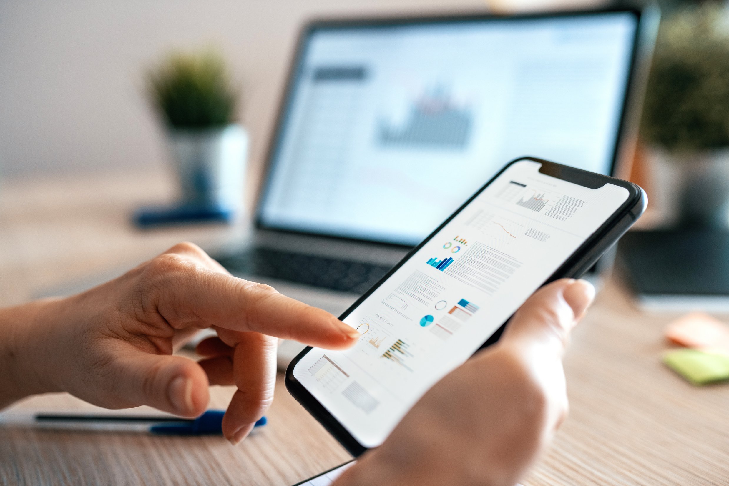 Close up photo of woman using mobile app for finance and stock trading